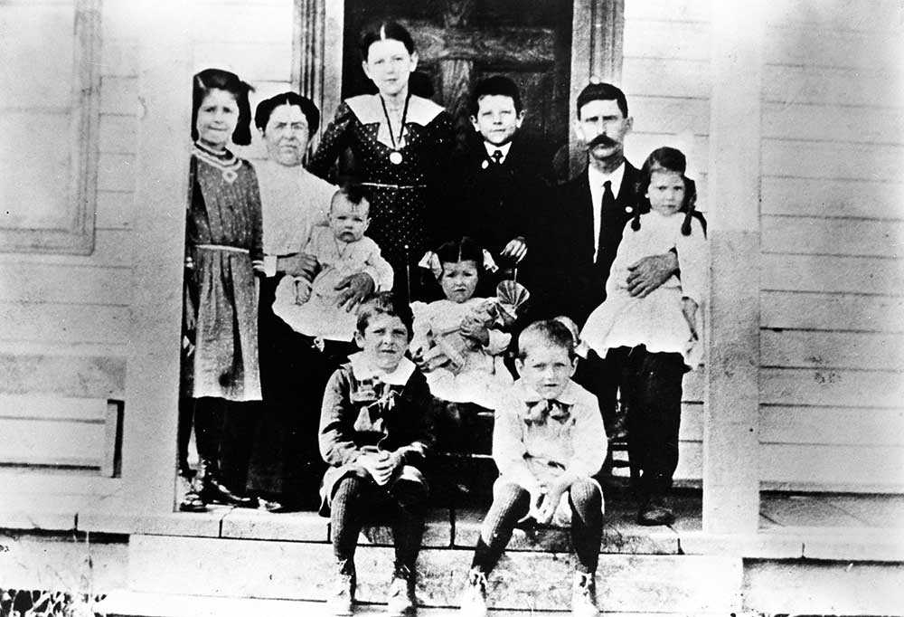 La famille de Simon Aumont, où seul le père et Irène (assise tenant une poupée), ont survécu au grand incendie qui a dévasté la région en 1916, Val Gagné (Ontario), [avant 1916]. Université d’Ottawa, CRCCF, Fonds TVOntario (C21), Reproduit de la collection de Germaine Robert, Val Gagné (Ontario).